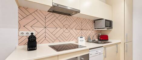 A modern kitchen with a microwave, toaster, and built-in oven.