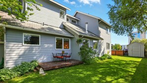 A two-story house with a covered patio and a small shed in the backyard. - Coastal Place - BEST location in Downtown (Anchorage)