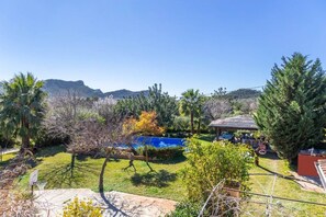 A backyard with a pool, a basketball hoop, and a gazebo. - Family Country House with Pool in Andratx (Port Andratx)