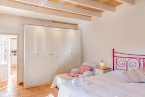 A bedroom with a bed, bedside tables, a wardrobe, and a nightstand. - Family Country House with Pool in Andratx (Port Andratx)