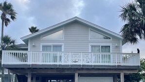 A two-story house with a balcony, a garage, and a covered entryway.