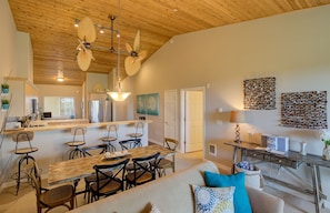 Relax in this inviting space with a dining table, sofa, and kitchen area.