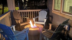 A deck with a fire pit and four Adirondack chairs. - Beach Tripping - Oyhut Bay Seaside Village (Ocean Shores)