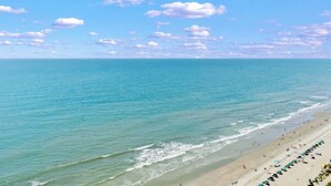 A beach with clear skies and calm waters. - Palace 2305 (Myrtle Beach)