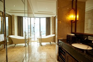A luxurious bathroom with a freestanding bathtub, a large mirror, and a marble floor. - Guangzhou Estandon Hotel (Guangzhou)