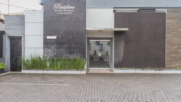 A modern building with a sign reading "Predina Business Residence." - RedDoorz @ Cikutra 3 (Bandung)