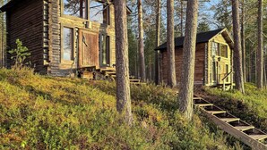 A log cabin with a wooden staircase leading to a deck. - Sompsanniemi by Interhome (Kuusamo)