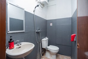 A bathroom with a sink, toilet, and shower. - RedDoorz Plus near Mall Kelapa Gading (Jakarta)