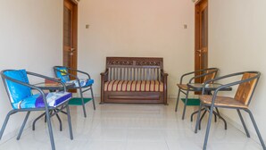 Una habitación con un sofá y cuatro sillas.