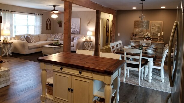 A spacious living area with a wooden dining table, white chairs, and a kitchen island. - Greer’s Ferry Lake & Little Red River Cabin (Heber Springs)