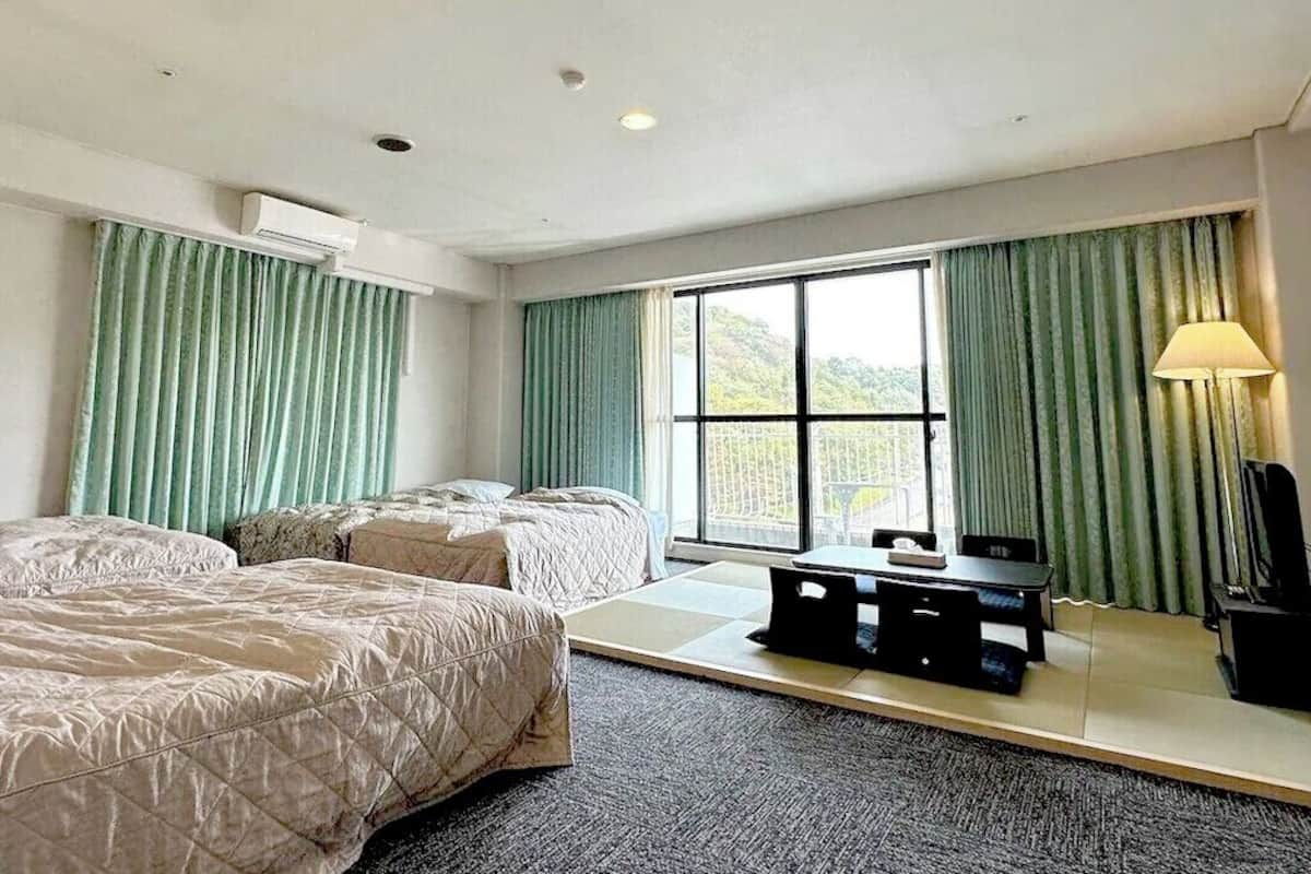 Deluxe Quadruple Room | Desk, blackout drapes, free WiFi, bed sheets