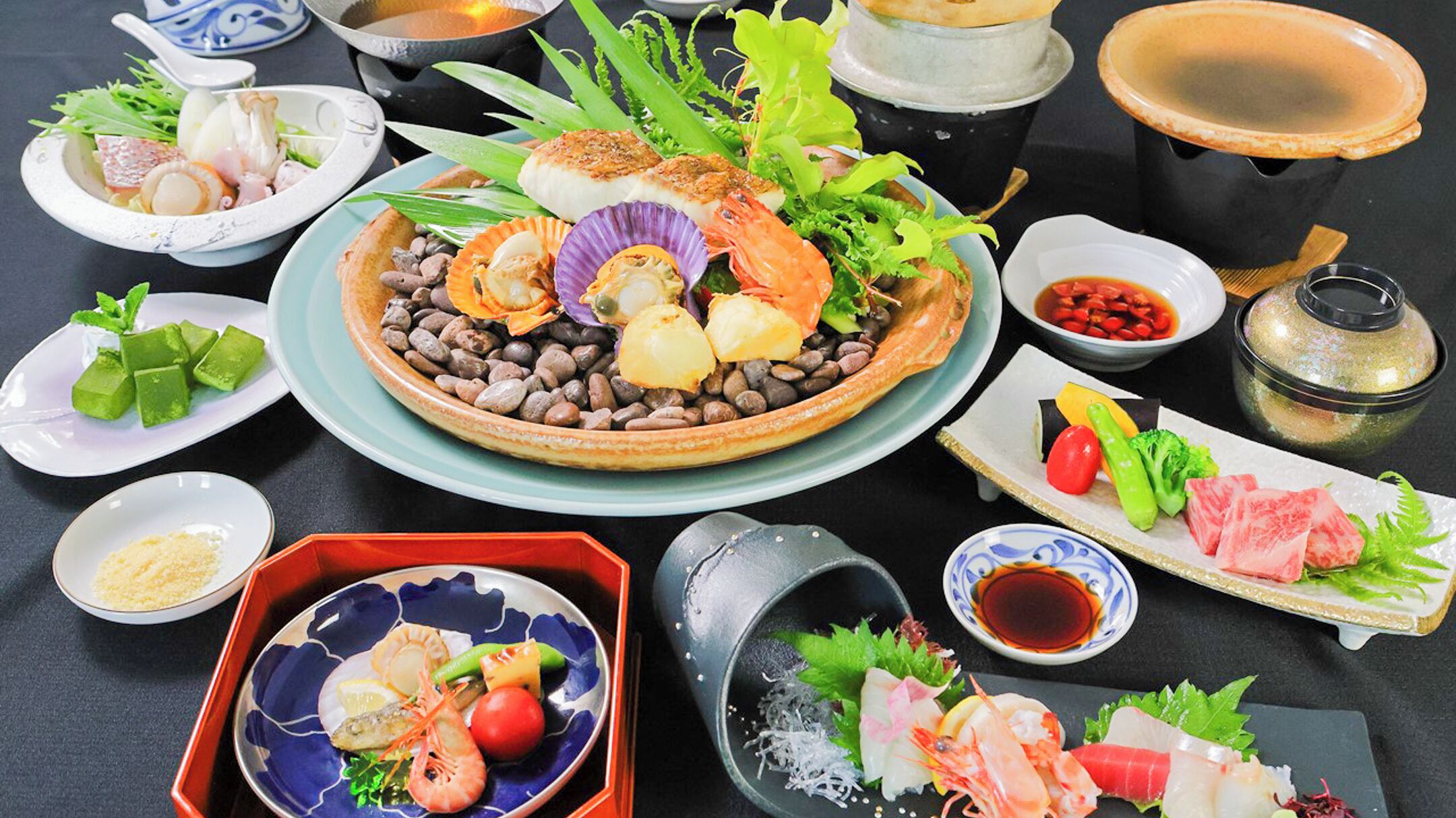 A variety of dishes, including seafood and vegetables, arranged on a table.