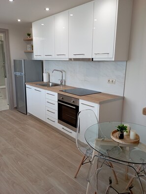 Deluxe Apartment, 1 Bedroom, Sea View | Private kitchen | Full-size fridge, oven, stovetop, coffee/tea maker