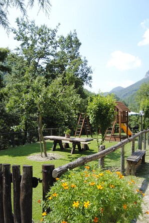 A playground with wooden structures and a picnic table.