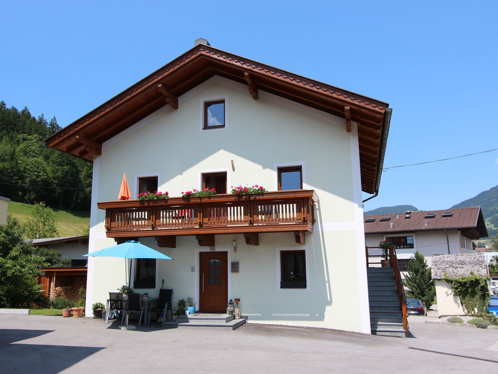 A two-story building with a balcony, a door, and a small window.