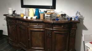 A wooden bar counter with a sink, various kitchen items, and a mirror above it. - Bed and breakfast Style (Rome)