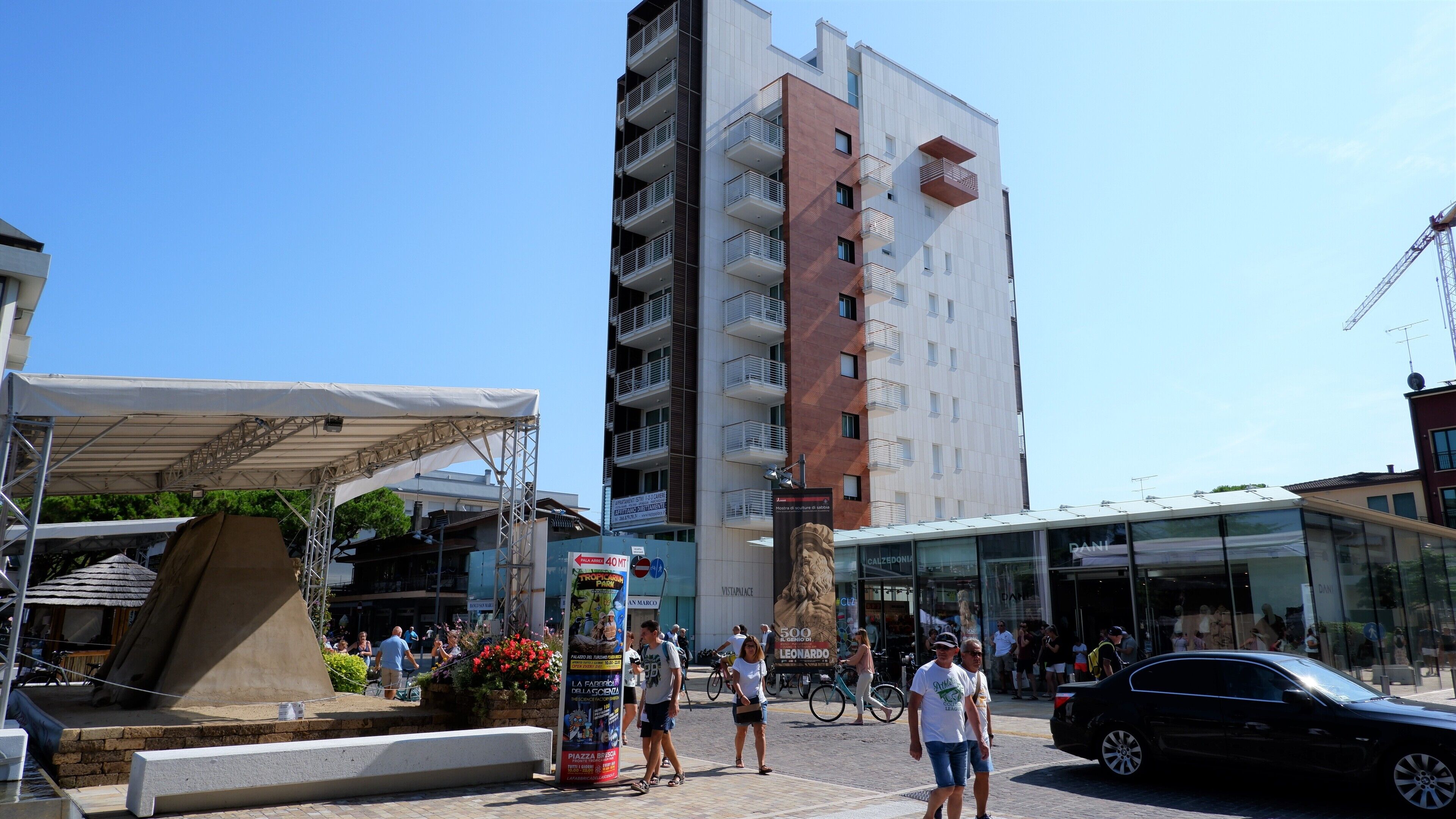 A modern building with multiple balconies and a glass facade.
