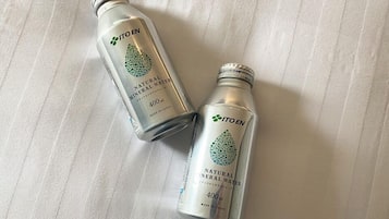 Two bottles of Itoen natural mineral water on a white textured surface.