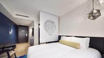 A modern hotel room with a large bed, a desk, and a wall-mounted artwork labeled "OSAKA".