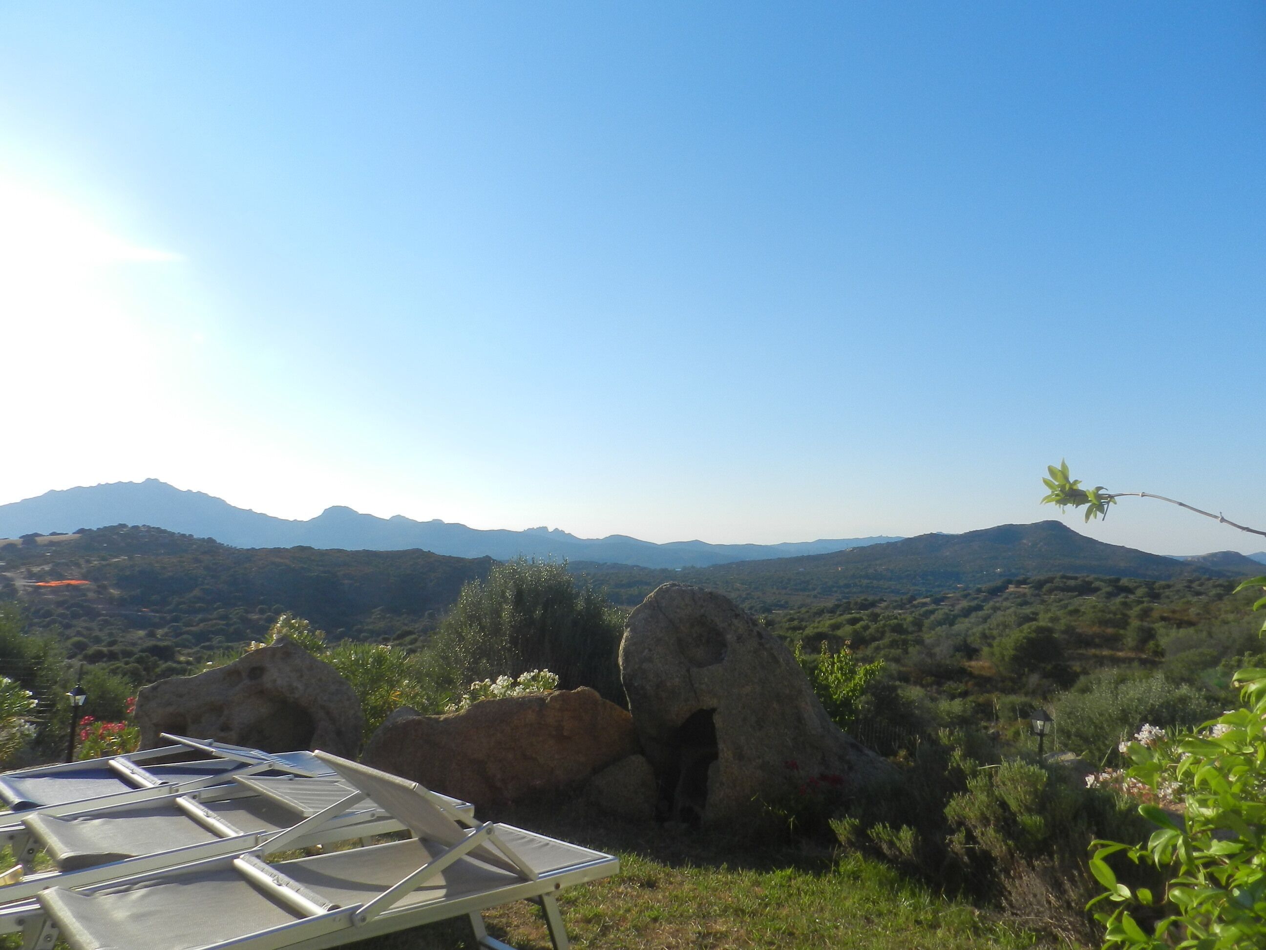 A view of a mountainous landscape with a clear sky.