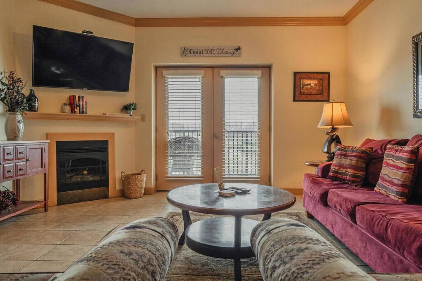 A living room with a fireplace, a television, a sofa, and a coffee table.