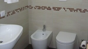 A bathroom with a bidet, toilet, and sink. - Verziere B&B (Jesi)
