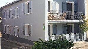 A two-story building with a balcony on the upper floor.