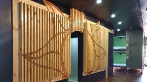 A modern interior with wooden paneling and a dark floor. - 3BU Hostel Baguio (Baguio)