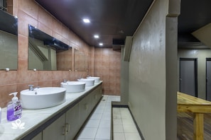A bathroom with three sinks, a mirror, and a wooden bench. - 3BU Hostel Baguio (Baguio)