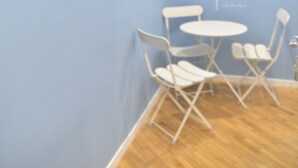 A room with a blue wall and a quote. There is a table and chairs. - All You Need Is Rome Guesthouse (Rome)