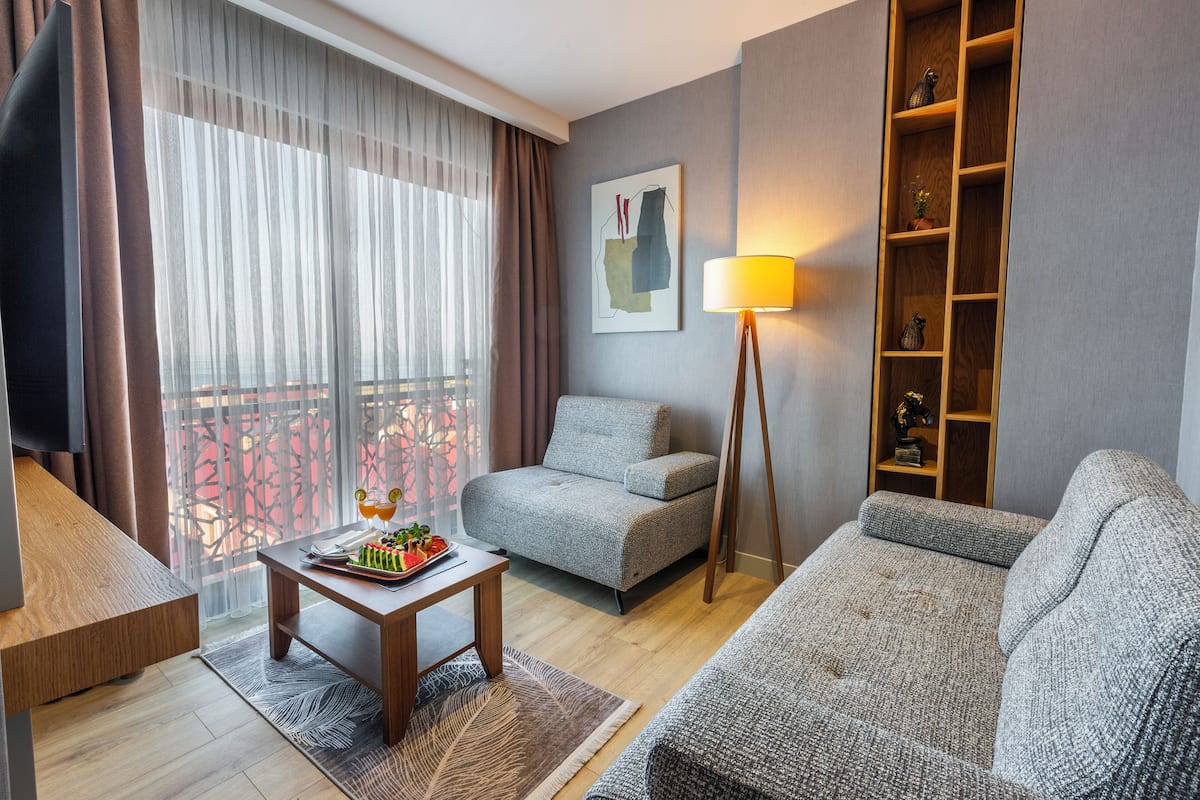 Deluxe Suite | Living area | 60-inch Smart TV with satellite channels, Netflix, streaming services