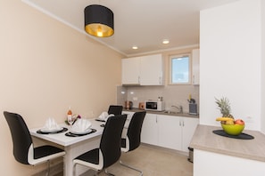 Family Apartment | Private kitchen | Full-size fridge, microwave, stovetop, coffee/tea maker