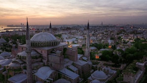 A historic building complex with multiple domes and minarets, surrounded by dense urban architecture. - Sura Luxury Million & Spa (Istanbul)
