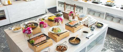 A buffet setup with various food items and drinks.