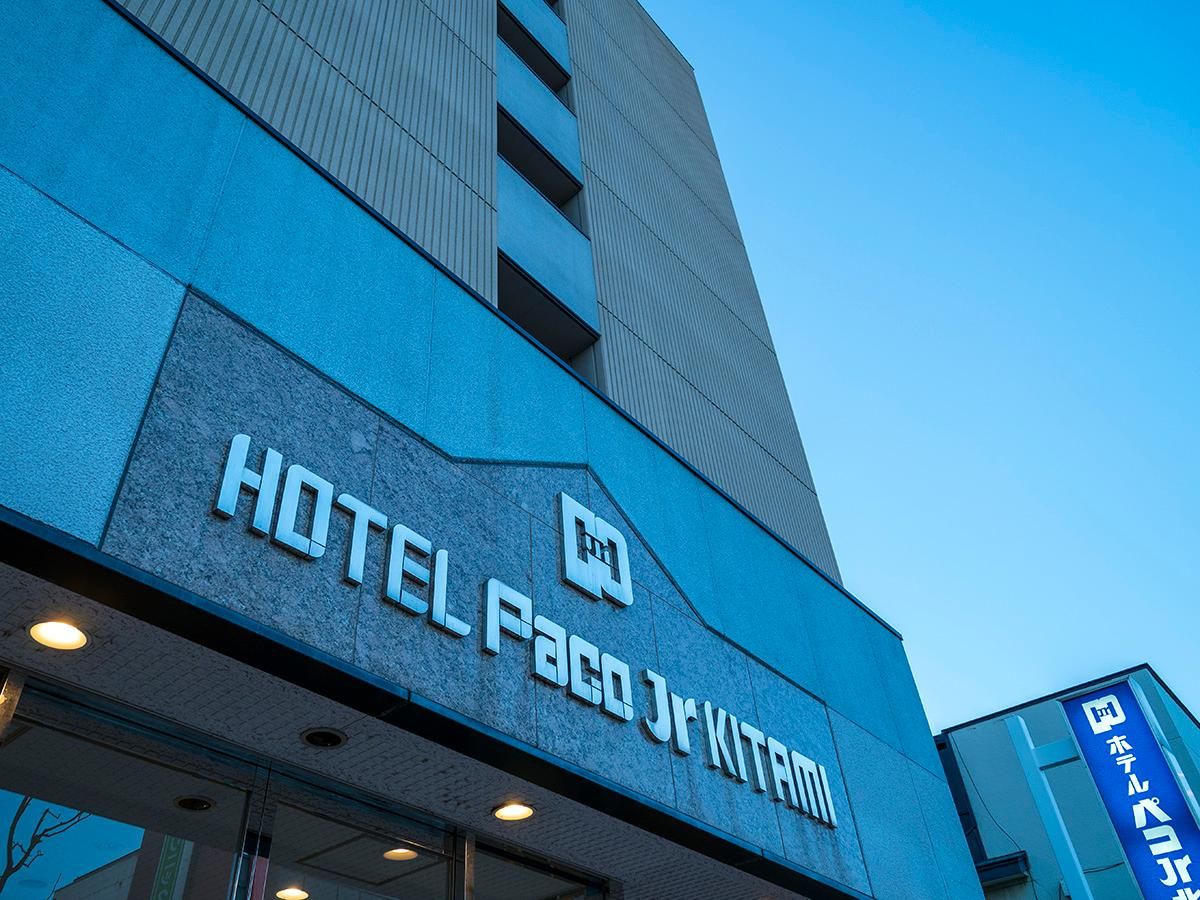 A hotel sign with the name 'HOTEL PACO JR KITAMI' in large letters.