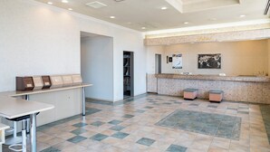 A hotel lobby with a reception desk, a seating area, and a tiled floor. - Hotel Paco Jr Kitami (Kitami)