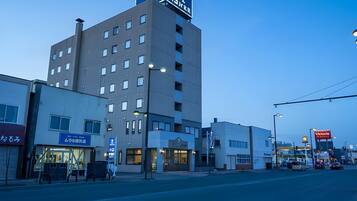 A multi-story hotel with a prominent sign on the top.
