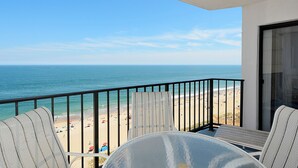 A balcony with a view of the beach and ocean. - XPLORIE ACTIVITIES & LINENS INCLUDED*!  PLAZA - 2BR/open den. Indoor/outdoor pools & Tiki Bar. (Ocean City)