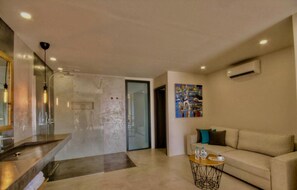 Relax in a stylish living area with a sofa set, coffee table, and minimalist art piece.