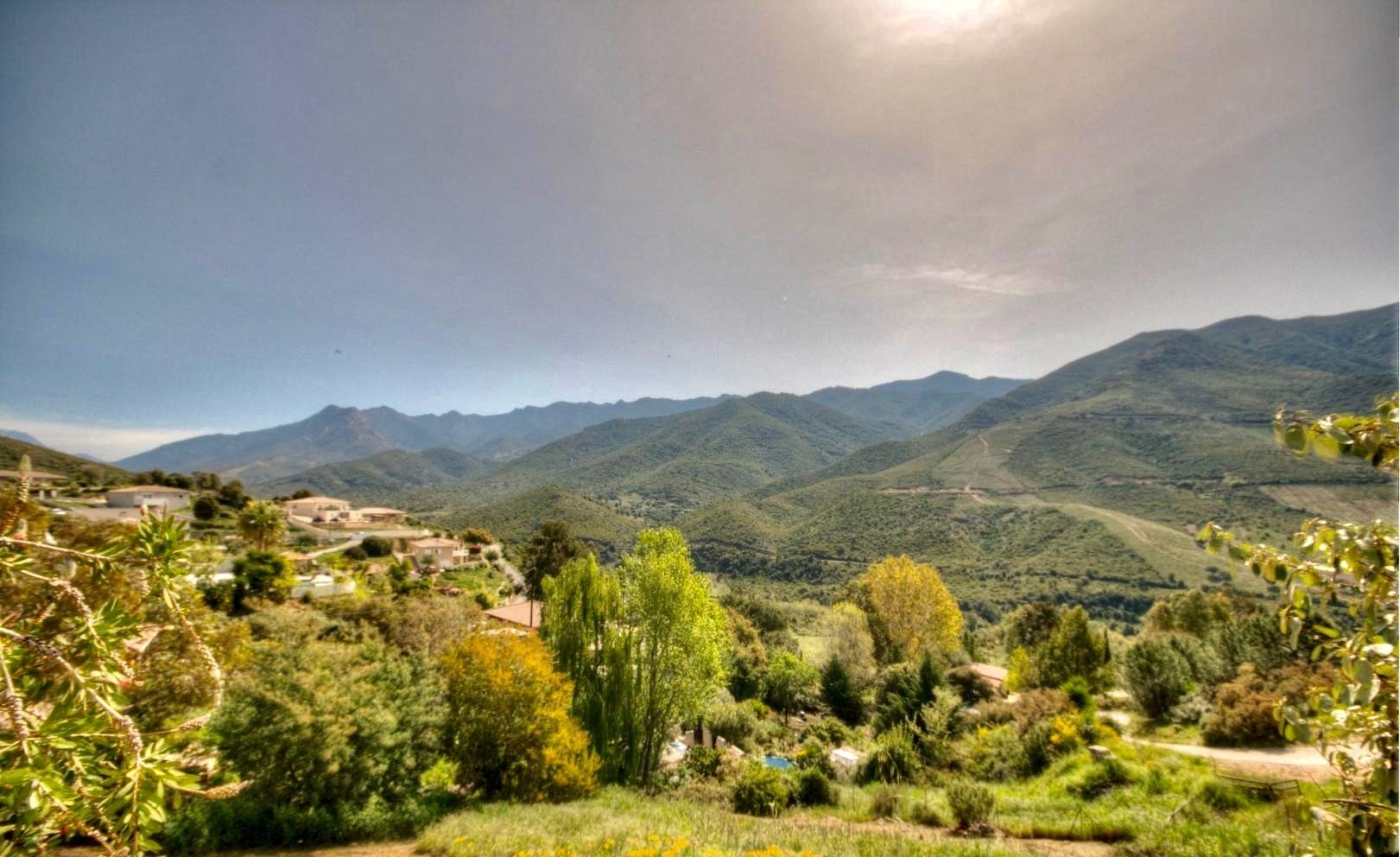 A mountainous landscape with a village in the valley.