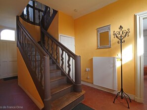 A staircase with wooden railings and a white door at the top.