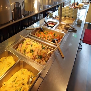 A buffet with multiple food stations, including a salad, a casserole, and a rice dish. - Business Hotel Taihei Annex (Matsuyama)