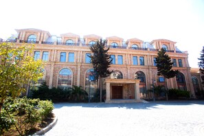 A large, historic building with a symmetrical facade, multiple windows, and a central entrance.