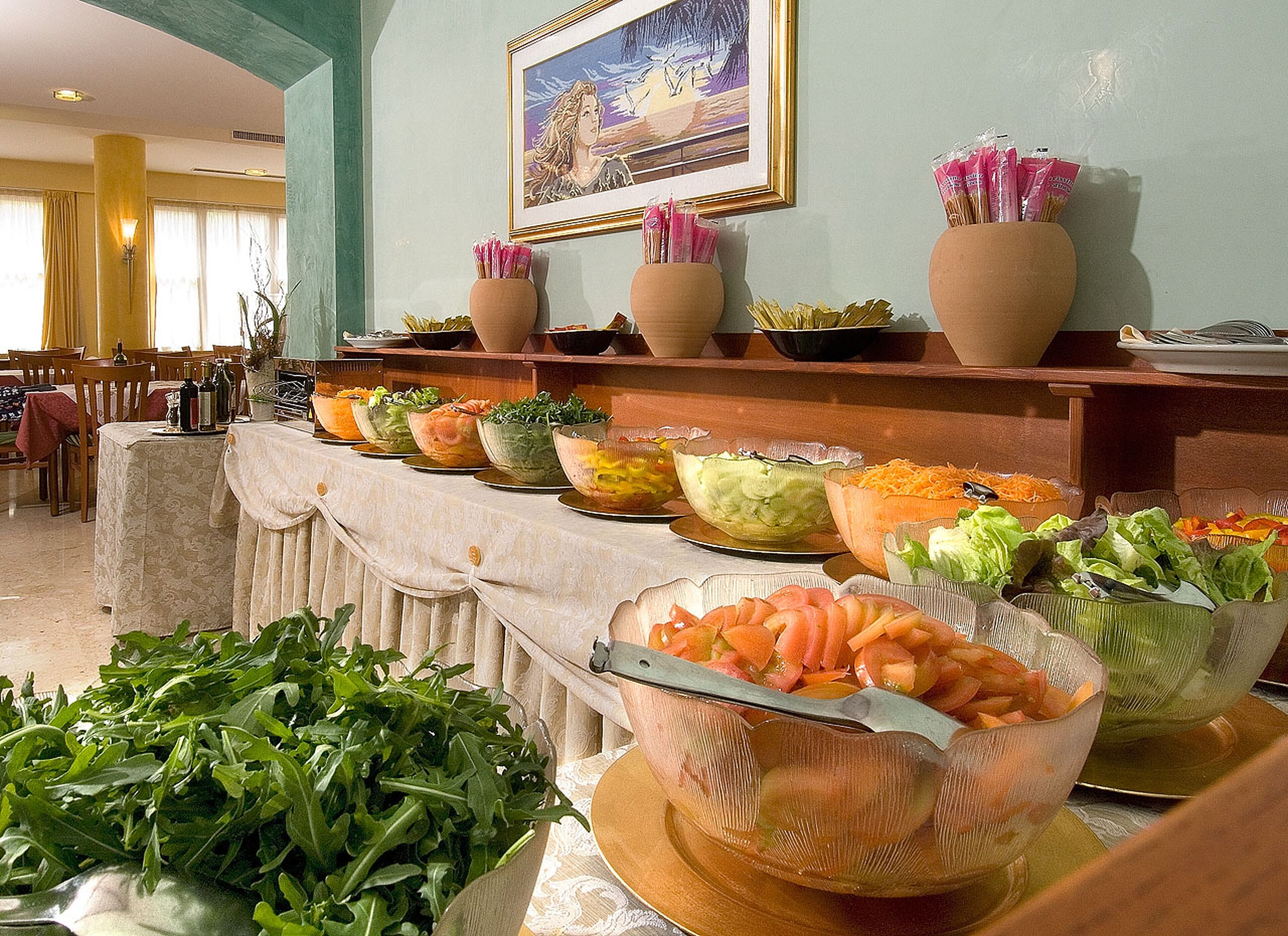 Un buffet con diversi piatti e un quadro appeso al muro.