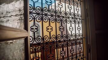 A wrought iron gate with intricate designs, likely leading to a building or property.