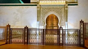 A traditional Moroccan gate with intricate designs, a large wooden door, and a tiled roof. - Riad Zidania (Meknes)