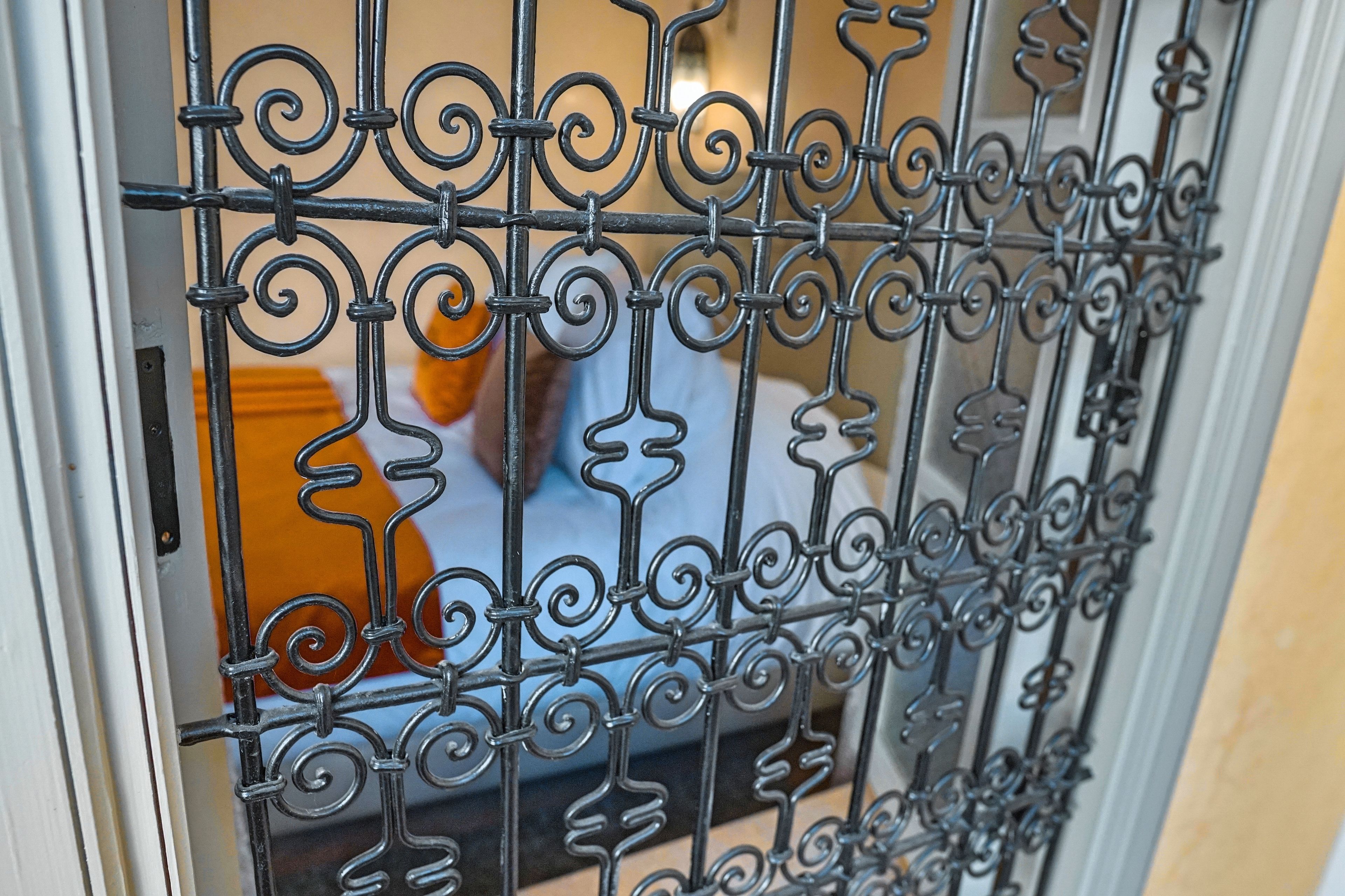 A close-up of a wrought iron gate with intricate designs.