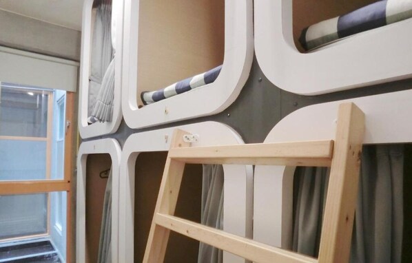 A room with a large window, a wooden ladder, and a curtain. - Sennong Homestay (Tainan)
