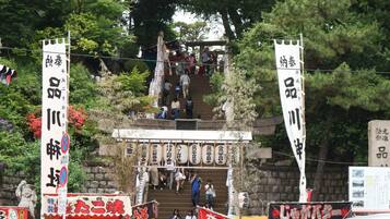 A traditional Japanese building with a staircase leading up to a shrine.