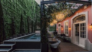 A rooftop terrace with a hot tub, outdoor seating, and a pergola with hanging lights. - Torel Palace Porto (Porto)